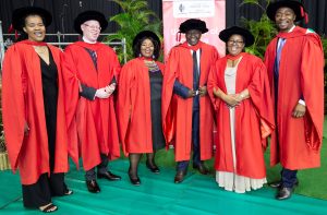 Education staffers celebrate the success of graduating with their PhDs.